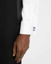 Man adjusting white dress shirt cuff wearing sterling silver three-dimensional dimpled golf ball cufflink, Jan Leslie 