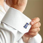 Man adjusting white dress shirt cuff wearing sterling silver three-dimensional dimpled golf ball cufflink, Jan Leslie