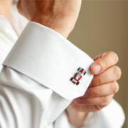 Man in navy suit adjusting white dress shirt cuff wearing sterling silver and blue enamel golf tee cufflink, Jan Leslie