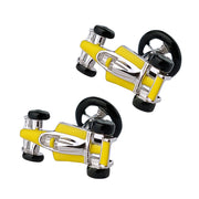 Underside view of pair of sterling silver three-dimensional Formula 1 racing car cufflinks with yellow enamel body panels showing polished silver chassis undercarriage, black enamel tires, and black enamel steering wheel toggle bar closure, Jan Leslie 