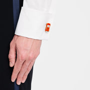 Man adjusting white French cuff dress shirt wearing sterling silver and orange enamel sports car cufflink on cuff, Jan Leslie