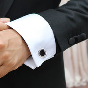 Man wearing sterling silver black onyx LOVE round cufflink on white French cuff with black tuxedo jacket by Jan Leslie