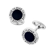 Pair of round silver cufflinks with black onyx center and engraved LOVE text border, front-facing view with bullet backs.