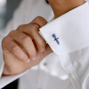 Man in navy suit and white dress shirt wearing sterling silver and blue enamel golf tee cufflink on cuff, Jan Leslie.