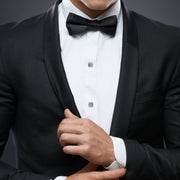 Man in black tuxedo wearing marcasite pavé cushion-square tuxedo studs on dress shirt with bow tie by Jan Leslie.