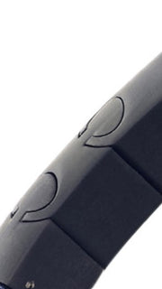 Close-up of matte black magnetic bracelet link showing engraved crescent moon motif detail by Jan Leslie.