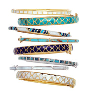 Channel-set gemstone gold vermeil bangle bracelet collection flat-lay showing eight colorways including mother of pearl, turquoise, sugilite, and multi-stripe inlay