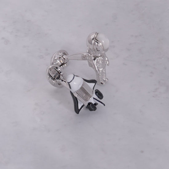 180 degree video of Jan Leslie's Shuttle & Astronaut Bobble Head Sterling Silver & Gemstone Cufflinks with open shuttle door on a marble background. 
