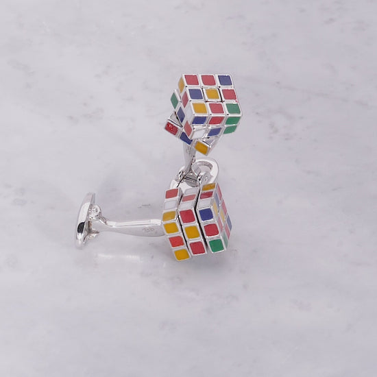 180 video of the Moving Puzzle Cube Multi Color Enamel & Sterling Silver Cufflinks on a marble background. 