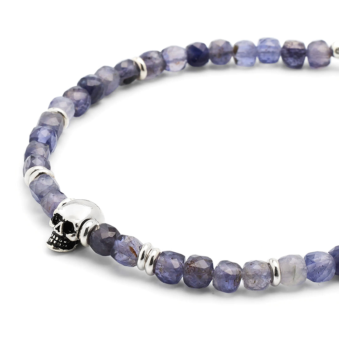 Close up of the faceted rutilated quartz, sterling silver spacers and skull on the Faceted Rutilated Quartz Gemstone Beaded Bracelet with Sterling Silver Skull. 