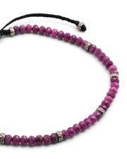 Close up of the faceted red ruby beads and sterling silver spacers on Jan Leslie's an Leslie Faceted Ruby Gemstone Bracelet with Black Pull Cord. 