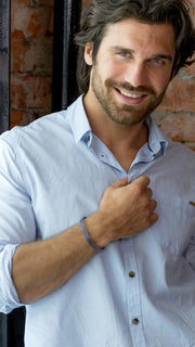 Male model showing off the Chevron Pattern Crushed  Inlay Sterling Silver Cuff Bracelet in Onyx. 
