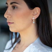 Left facing model wearing Fiji 18K Gold One of a Kind Gemstone Earrings. 