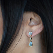 Close up of a female models ear wearing the Fiji 18K Gold One of a Kind Gemstone Earrings. 
