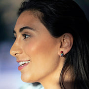 Smiling model wearing Jan Leslie's Rainbow Enamel Gummy Bear Stud Sterling Silver Earrings. 