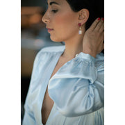 Rough ruby trillion and oval moonstone diamond drop earrings in 18k gold vermeil worn close-up by model