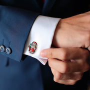Close up of models wrist wearing the Enamel Santa Claus Sterling Silver Cufflinks on a white cuffed shirt with blue suit jacket. 