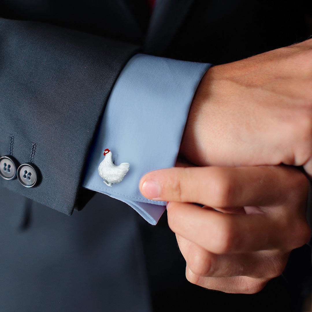 Male model wearing The Chicken and the Egg Sterling Silver Cufflinks from Jan Leslie on a light blue cuffed shirt with blue sports coat. 
