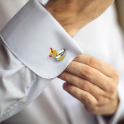 Close up of male models wrist showing off Devil Ducky Sterling Silver Bobble Head Cufflinks on a white cuffed shirt. 