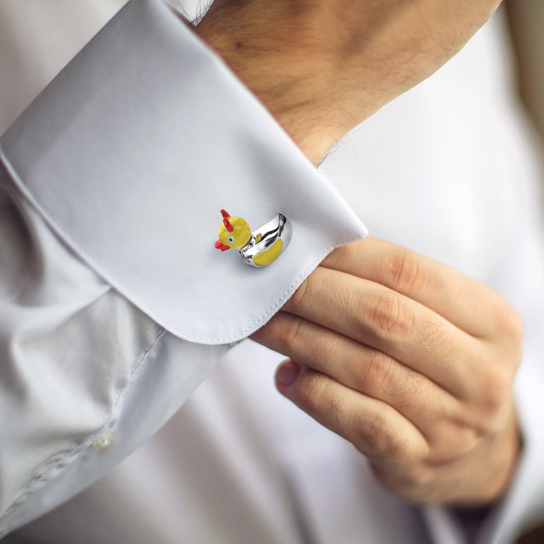 Close up of male models wrist showing off Devil Ducky Sterling Silver Bobble Head Cufflinks on a white cuffed shirt. 