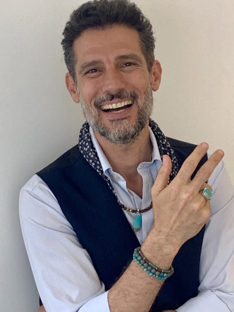 Smiling male model wearing Cobra Etched Tiger's Eye Sterling Silver Ring. 