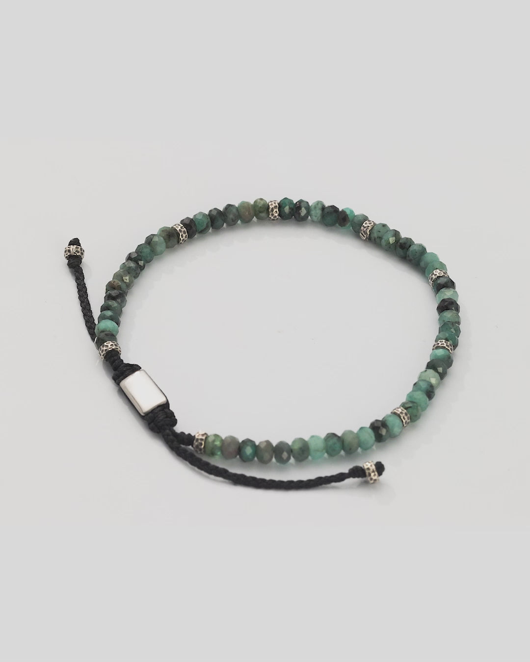 360 video of Jan Leslie Faceted Emerald Gemstone Bracelet with Black Pull Cord. Video shows full bracelet and closeup of faceted emeralds and sterling silver spacers. 