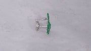 360 video of sterling silver and green enamel cannabis leaf cufflinks on marbled background. 