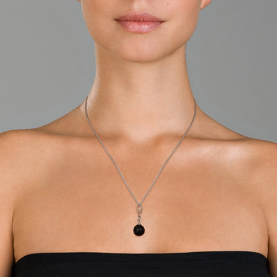 Model wearing the Mystic Knot Sterling Silver Necklace in Carved Onyx. 