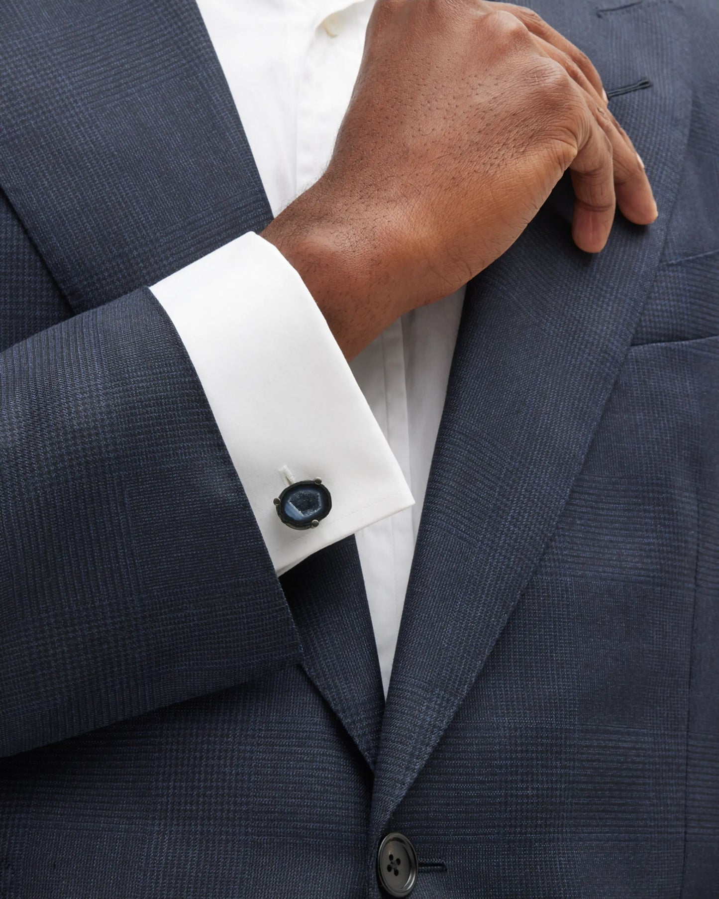 Close up of male models wrist donning Druzy Crystallized Gemstone Sterling Silver Cufflinks on white cuffed shirt and gray suit jacket. 