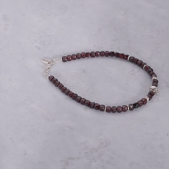 180 degree video of the Faceted Garnet Gemstone Beaded Bracelet with Sterling Silver Skull. 