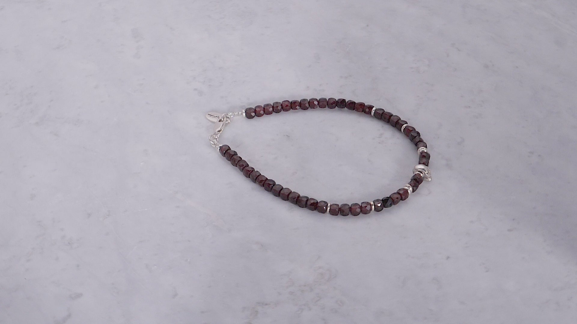 180 degree video of the Faceted Garnet Gemstone Beaded Bracelet with Sterling Silver Skull. 