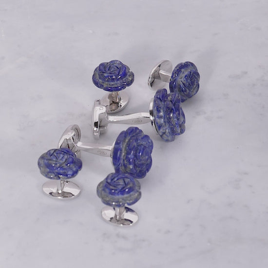 180 of Jan Leslie's Hand Carved Gemstone Rose Sterling Silver Cufflinks and Tuxedo Studs in lapis on a marble background. 