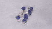 180 of Jan Leslie's Hand Carved Gemstone Rose Sterling Silver Cufflinks and Tuxedo Studs in lapis on a marble background. 