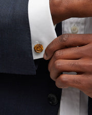 Man in tuxedo wearing tiger's eye carved rose cufflinks